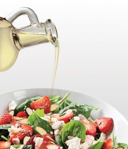 Almond oil pouring onto salad