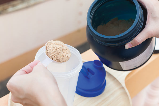 Scooping protein powder from container