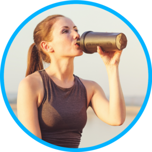 woman drinking protein shake while exercising