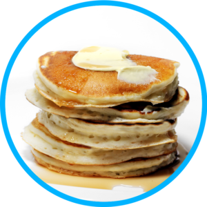 A short stack of fluffy pancakes made with almond flour, topped with a pat of butter and smothered with syrup.